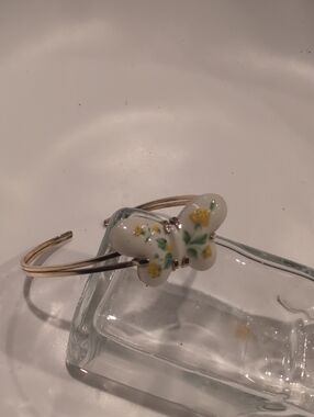 Avon Gold-Tone Open Cuff Bracelet with White Butterfly and Yellow Floral Detail